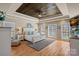 Spacious main bedroom features a wood tray ceiling, many windows, and warm, wood-look floors at 105 Elizabeth Brook Dr, Davidson, NC 28036