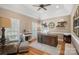 Home office with a dark wood desk, comfortable seating, and natural light at 105 Elizabeth Brook Dr, Davidson, NC 28036