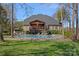 An inviting backyard featuring a sparkling pool, lounging chairs, and a covered patio, perfect for relaxation at 105 Elizabeth Brook Dr, Davidson, NC 28036
