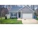 Charming home with well-maintained lawn, attached garage, and stylish curb appeal at 1123 Fieldstone Rd, Mooresville, NC 28115