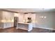 Open-concept kitchen featuring an island, stainless appliances, and hardwood floors at 1123 Fieldstone Rd, Mooresville, NC 28115