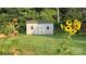 A newly constructed backyard shed with white trim and shingled roof sits perfectly on a beautiful lot at 1123 Fieldstone Rd, Mooresville, NC 28115