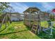 Backyard play set featuring swing set, elevated playhouse, and soccer goal on well-maintained lawn at 113 Windsong Ct, Gastonia, NC 28056