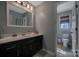 Modern bathroom with dark vanity, white countertop and toilet with a window at 113 Windsong Ct, Gastonia, NC 28056