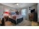 Bedroom with sports decor, ceiling fan and a large window at 113 Windsong Ct, Gastonia, NC 28056