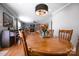 Dining room with wood table, chairs, hardwood floors, and view into the living room at 113 Windsong Ct, Gastonia, NC 28056