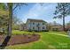 Beautiful two-story home with lush green lawn, mature trees, and well-kept landscaping at 113 Windsong Ct, Gastonia, NC 28056