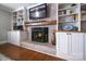 Living room fireplace with built-in shelving, brick surround, and decorative mantel at 113 Windsong Ct, Gastonia, NC 28056