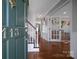 Inviting foyer with hardwood floors, staircase, and view into a playroom at 113 Windsong Ct, Gastonia, NC 28056