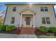 Inviting front entrance with brick steps, manicured bushes, and charming architectural details at 113 Windsong Ct, Gastonia, NC 28056