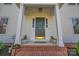 Elegant front porch features brick steps, side lights, and manicured landscaping at 113 Windsong Ct, Gastonia, NC 28056