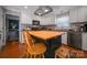 Kitchen with white cabinets, hardwood floors, butcher block island, and modern appliances at 113 Windsong Ct, Gastonia, NC 28056