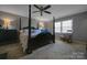 Serene primary bedroom with a four-poster bed, ceiling fan and natural light at 113 Windsong Ct, Gastonia, NC 28056