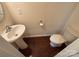 Small bathroom with a pedestal sink, toilet, hardwood flooring, and neutral wall color at 13615 Browhill Ln, Charlotte, NC 28278