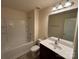 Bathroom featuring a single sink vanity, toilet, and tub shower with a large mirror at 13615 Browhill Ln, Charlotte, NC 28278