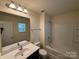 Bathroom featuring a vanity with a mirror, toilet, and shower-tub combination with tile surround at 13615 Browhill Ln, Charlotte, NC 28278