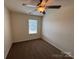 Bedroom with neutral paint, ceiling fan and window providing natural light at 13615 Browhill Ln, Charlotte, NC 28278