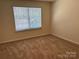 Bedroom with large window letting in plenty of light; carpeted floor and neutral walls at 13615 Browhill Ln, Charlotte, NC 28278