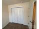 Cozy bedroom with bi-fold closet doors and neutral-colored walls at 13615 Browhill Ln, Charlotte, NC 28278