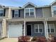 Charming multi-colored townhome featuring stone accents, a garage, and well-maintained landscaping at 13615 Browhill Ln, Charlotte, NC 28278