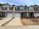 Attractive townhome exteriors showcase varying neutral colors, garages, and tidy front landscaping at 13615 Browhill Ln, Charlotte, NC 28278