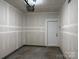 Unfinished garage with freshly installed drywall, a garage door opener, and access door to inside the home at 13615 Browhill Ln, Charlotte, NC 28278