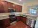 Kitchen with stainless steel appliances, granite countertops, and dark cabinets, perfect for cooking at 13615 Browhill Ln, Charlotte, NC 28278
