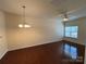 Bright living room with hardwood floors, chandelier and a ceiling fan, and natural light from a window at 13615 Browhill Ln, Charlotte, NC 28278