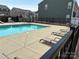 Pool area surrounded by lounge chairs and townhomes at 13615 Browhill Ln, Charlotte, NC 28278