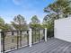 Exterior view from balcony with black metal railings and views of surrounding trees and buildings at 1409 Kenilworth Ave, Charlotte, NC 28203
