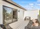 Relaxing balcony with sliding door access to the indoors and comfortable wicker seating with colorful pillows at 1409 Kenilworth Ave, Charlotte, NC 28203