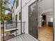 View of an open floor plan from the balcony featuring stainless steel appliances and hardwood floors at 1409 Kenilworth Ave, Charlotte, NC 28203
