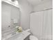 Clean bathroom with a white vanity, sleek mirror, and shower-tub combination with subway tile at 1409 Kenilworth Ave, Charlotte, NC 28203