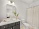 Bathroom featuring gray vanity with a white countertop and shower with curtain at 1409 Kenilworth Ave, Charlotte, NC 28203