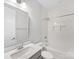Modern bathroom featuring white tile, a gray vanity, and a sleek mirror at 1409 Kenilworth Ave, Charlotte, NC 28203