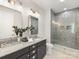 Modern bathroom with double sinks, granite countertops, and walk-in shower at 1409 Kenilworth Ave, Charlotte, NC 28203