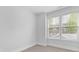 Corner bedroom with carpet, large window view, and white trim at 1409 Kenilworth Ave, Charlotte, NC 28203