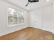 Well-lit bedroom with hardwood floors, ceiling fan, and a double door closet at 1409 Kenilworth Ave, Charlotte, NC 28203