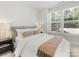 Well-lit bedroom with cozy decor, soft lighting, and two large windows at 1409 Kenilworth Ave, Charlotte, NC 28203