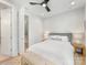 Well-lit bedroom features a ceiling fan, white bedding, and carpet at 1409 Kenilworth Ave, Charlotte, NC 28203