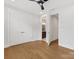 Bedroom featuring wood floors, ceiling fan, and an open doorway to an ensuite bathroom at 1409 Kenilworth Ave, Charlotte, NC 28203