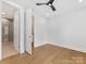 Bright bedroom with open doorway to a tiled bathroom and wood floors at 1409 Kenilworth Ave, Charlotte, NC 28203