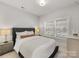 Serene bedroom featuring a large window for natural light and neutral decor for a calming ambiance at 1409 Kenilworth Ave, Charlotte, NC 28203