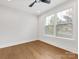 Bright bedroom featuring hardwood floors, a ceiling fan and large windows at 1409 Kenilworth Ave, Charlotte, NC 28203