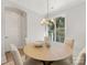 Bright dining room with a round table, four chairs, and a modern chandelier at 1409 Kenilworth Ave, Charlotte, NC 28203