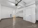 Spacious garage with epoxy flooring, white walls, and access to an interior door at 1409 Kenilworth Ave, Charlotte, NC 28203