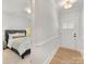Bright hallway with hardwood floors leads to a bedroom and entryway, showcasing the home's welcoming layout at 1409 Kenilworth Ave, Charlotte, NC 28203