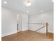 Open hallway with hardwood flooring, white trim, and access to the bathroom at 1409 Kenilworth Ave, Charlotte, NC 28203