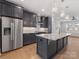 Modern kitchen featuring stainless steel refrigerator and range hood at 1409 Kenilworth Ave, Charlotte, NC 28203