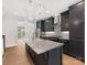 Modern kitchen features an island, stainless steel appliances, and granite countertops at 1409 Kenilworth Ave, Charlotte, NC 28203